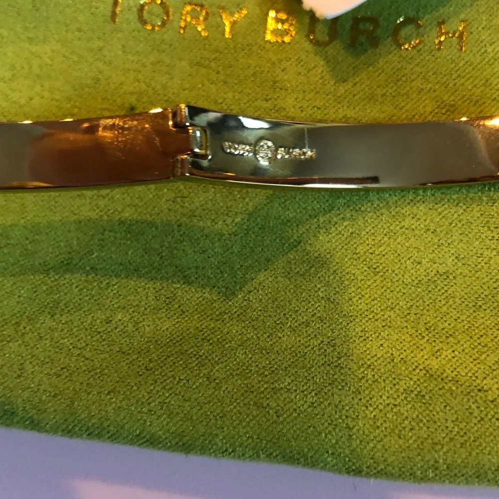 Authentic Tory Burch New/tag and pouch. Enamel Floral Hinge gold tone bracelet.